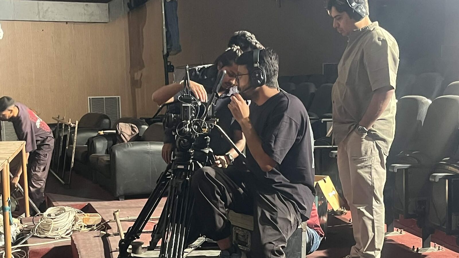 Camera crew operating a cinema camera on a dolly