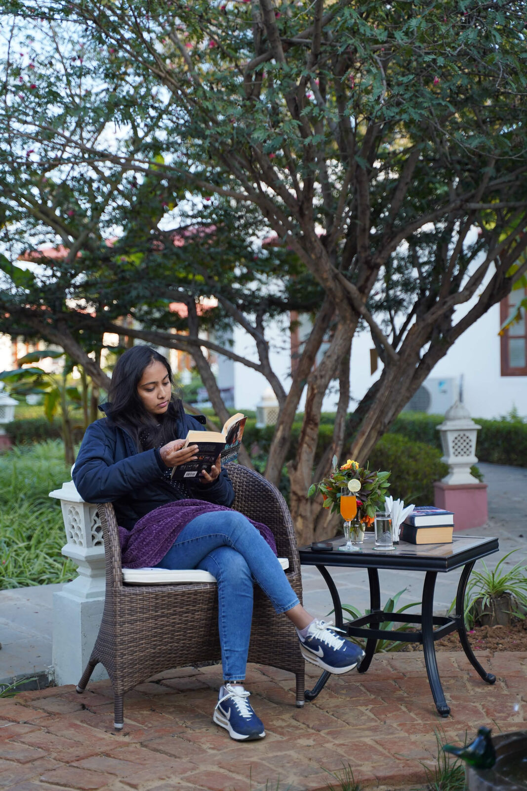 Woman reading in a garden lounge chair