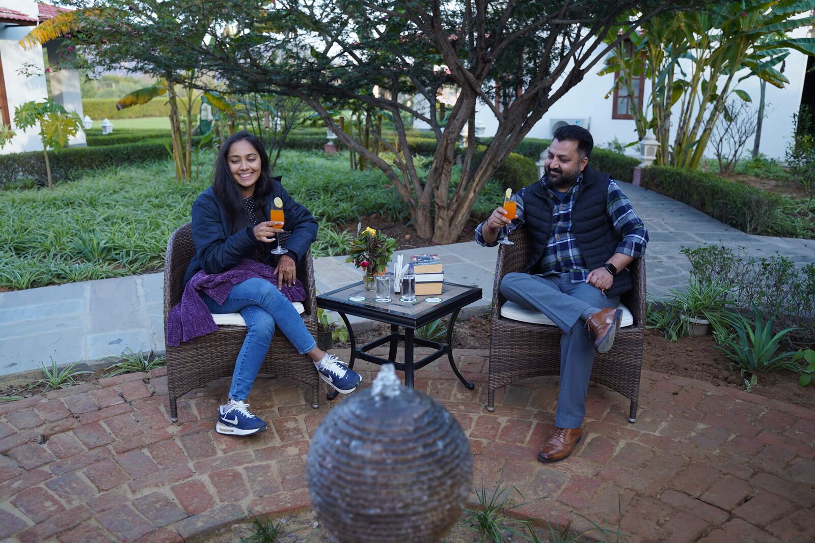 Couple enjoying drinks in a resort garden