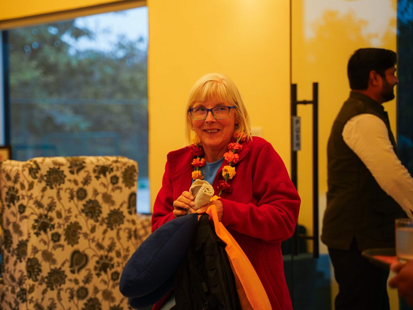 Guest wearing a marigold garland in the resort lobby