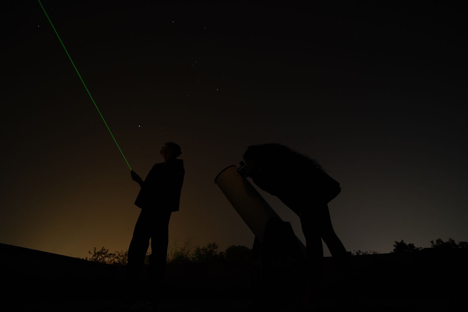 Silhouetted crew on a night shoot under the stars