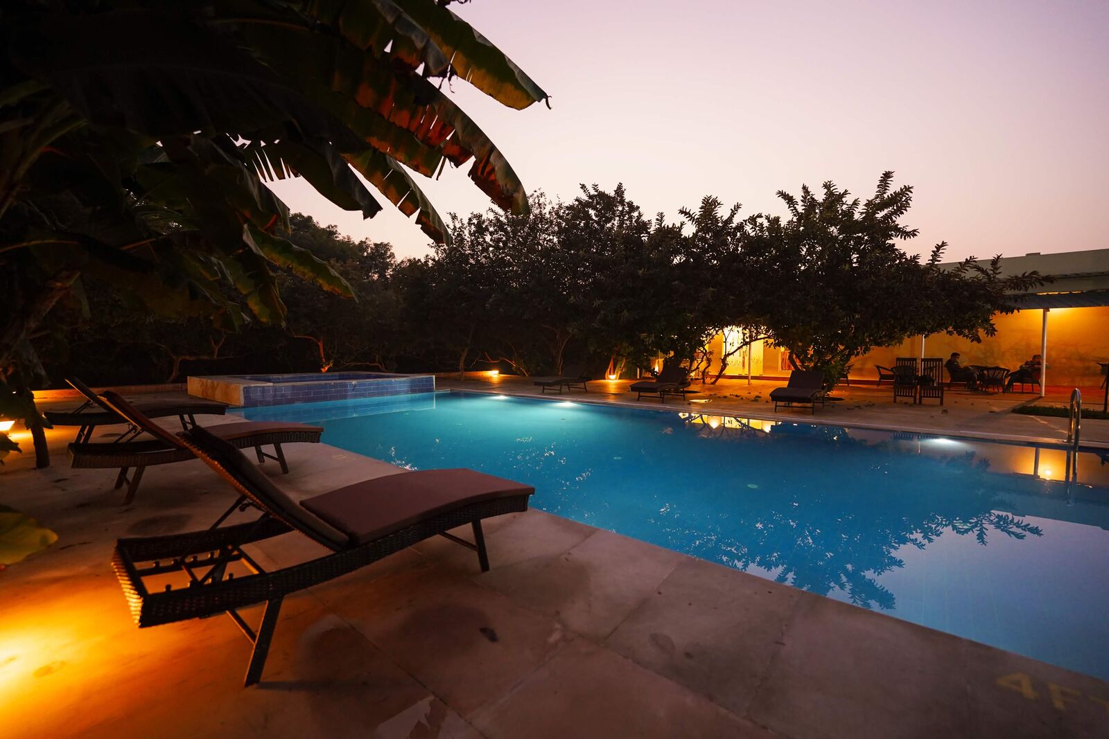 Illuminated resort pool at dusk